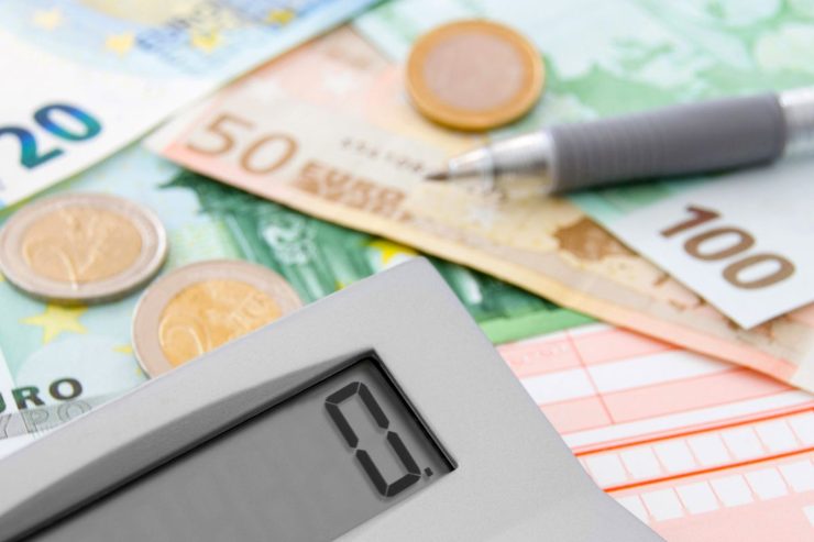 banconote e monete euro con calcolatrice e penna