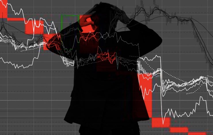 uomo disperato per il grafico dei mercati finanziari in rosso 